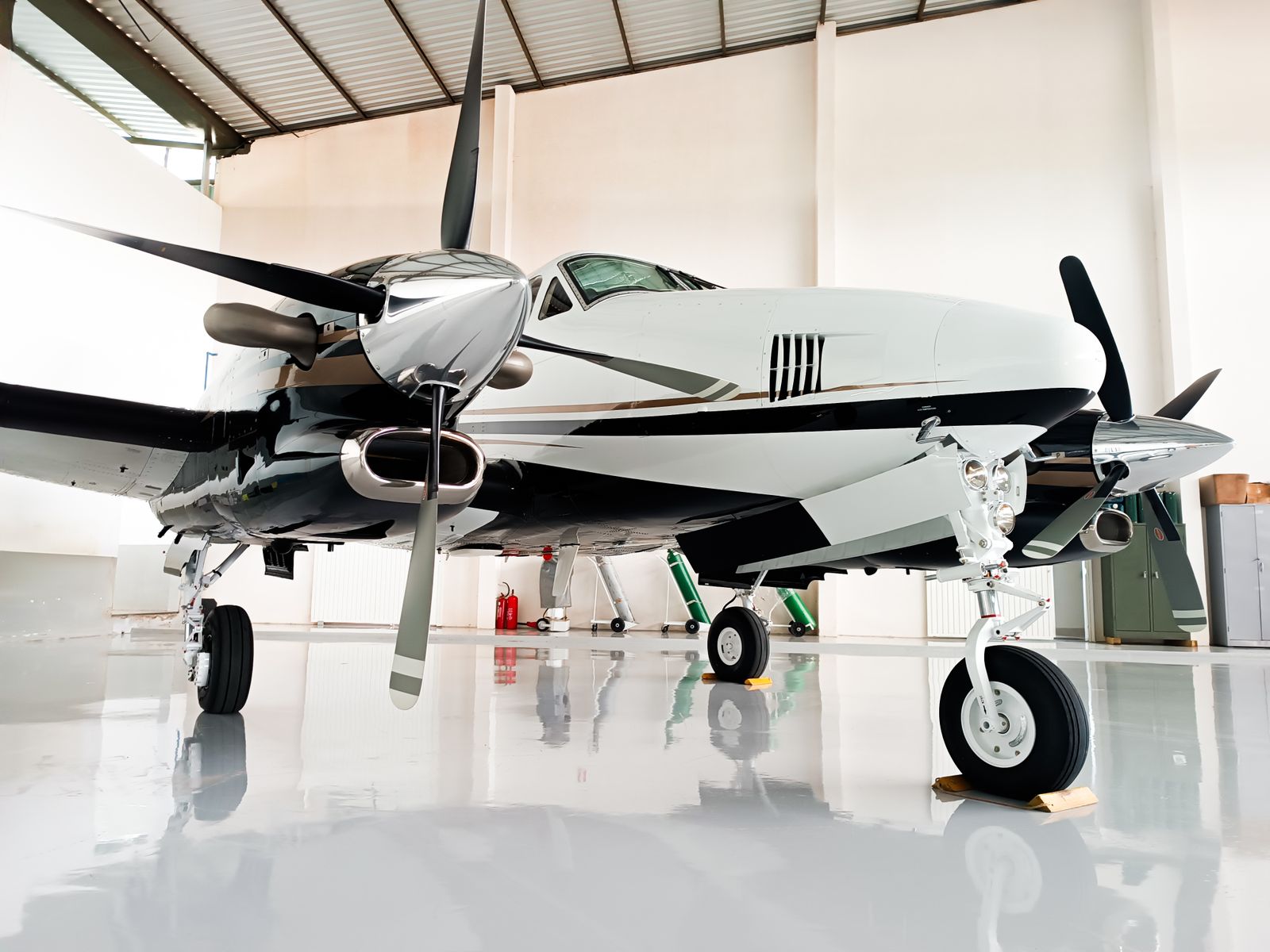 Aircraft parked on a mirror-gloss white hangar floor